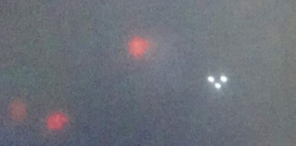Man Finds Flying Triangle UFO & Other Red Lights in Photo