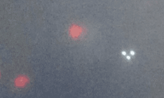 Man Finds Flying Triangle UFO & Other Red Lights in Photo
