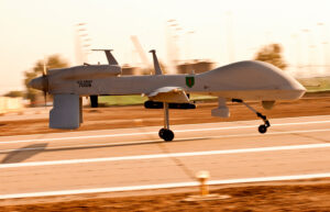 A Gray Eagle unmanned aircraft makes its way down an airfield on Camp Taji, Iraq, before a surveillance mission in the Baghdad area. F Company, “FENIX,” will become an official part of the Combat Aviation Brigade, 1st Infantry Division, in the spring, adding its capabilities to the strength of the CAB.